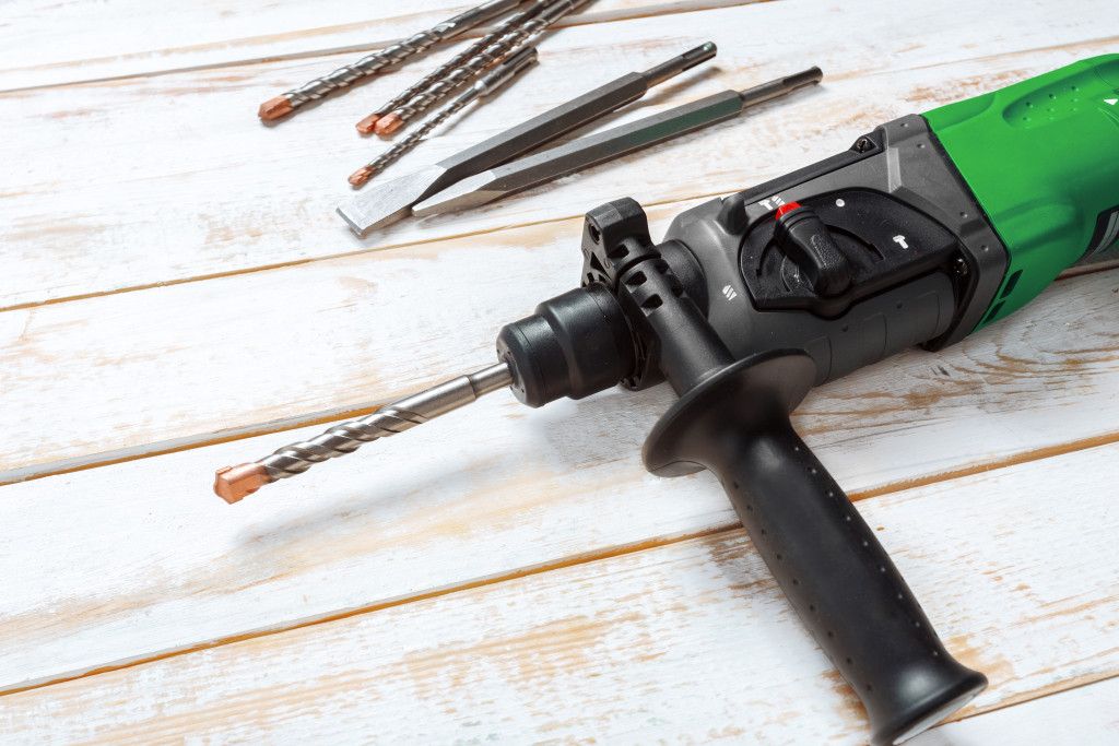electric-hammer-drill-lies-on-a-wooden-table.jpg